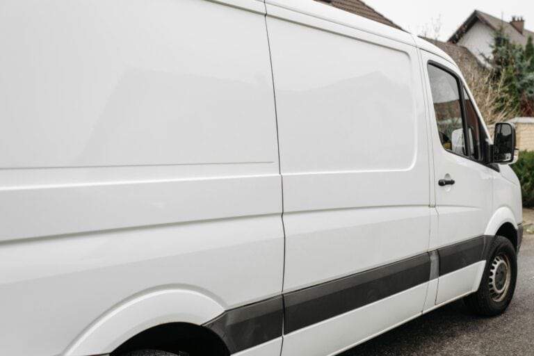 A white moving van in front of a house