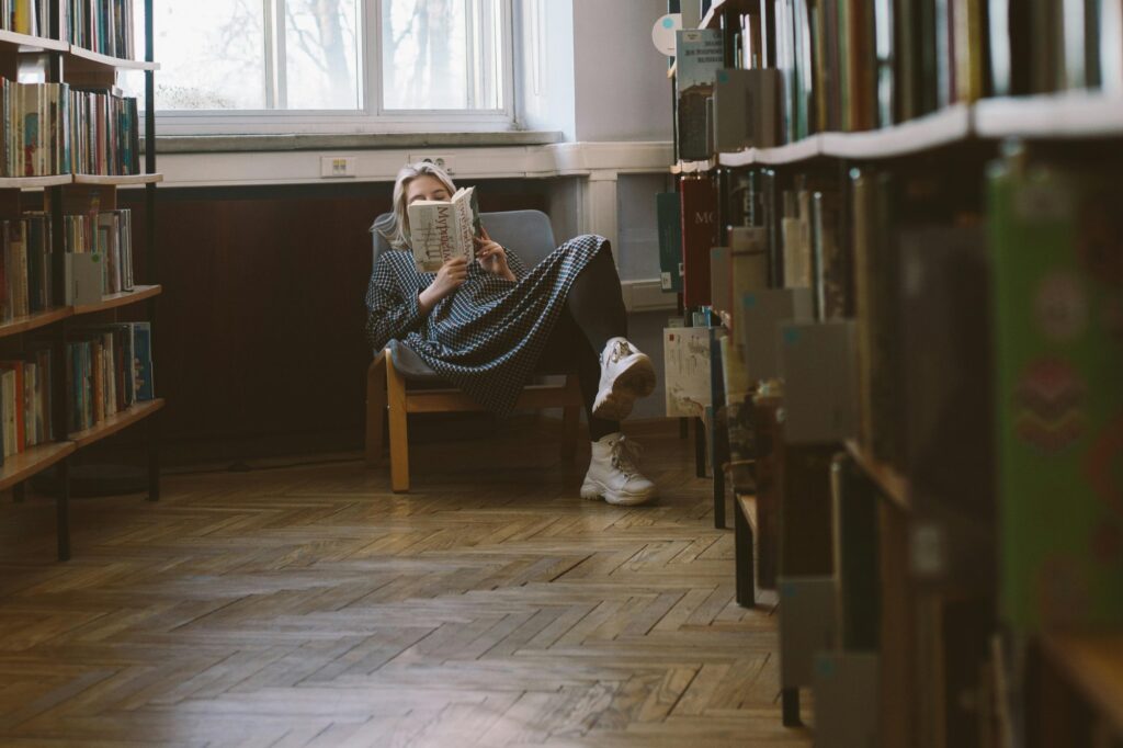 A student reading a book in the library