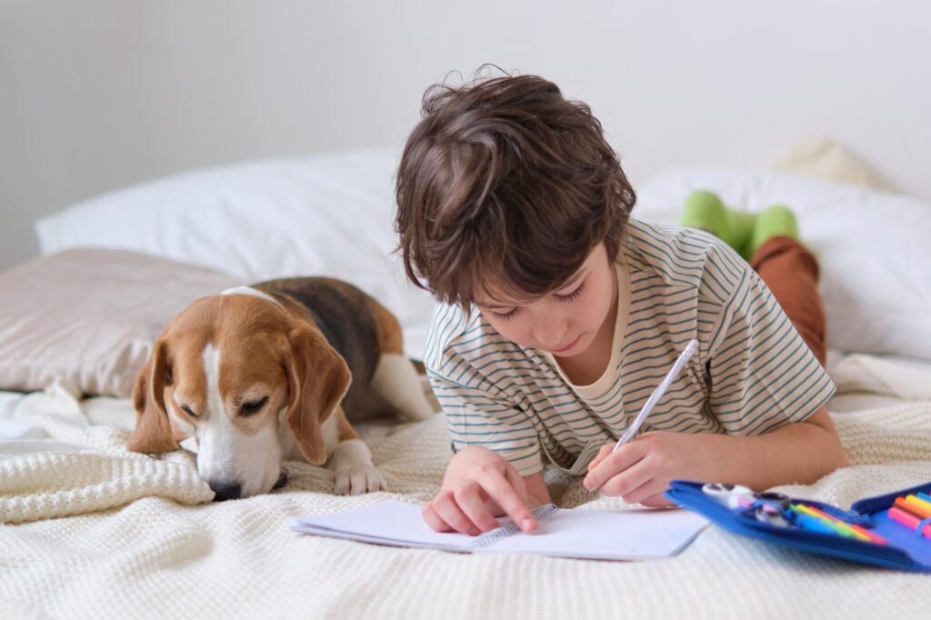A child and his pet on the bed