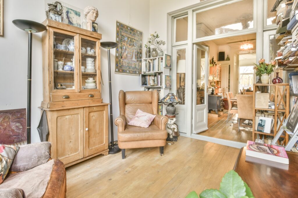 A living room filled with furniture, books, and vintage items in the concept of 'How to Pack Household Items Safely for a Move'.