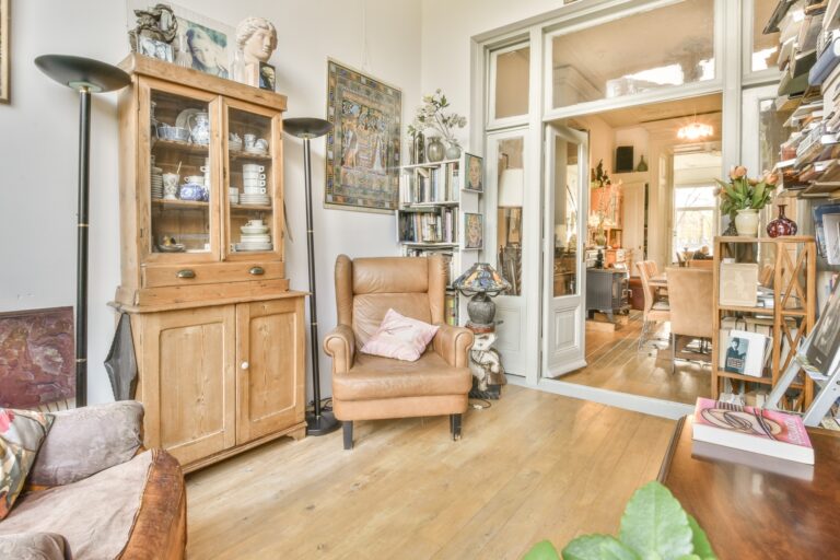 A living room filled with furniture, books, and vintage items in the concept of 'How to Pack Household Items Safely for a Move'.