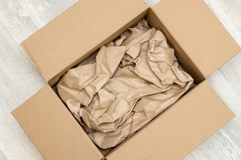 Top view of an opened cardboard with packing paper